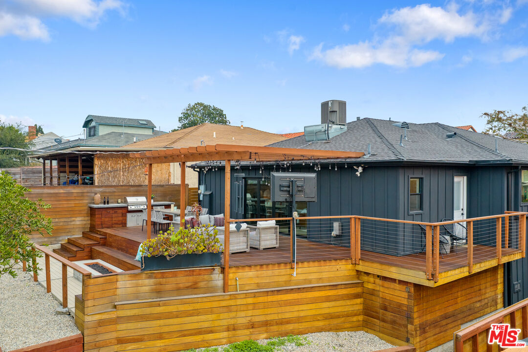 1645 South Sierra Bonita Avenue Los Angeles, CA 90019 - Photo 61 of 62 a view of a patio with swimming pool table and chairs