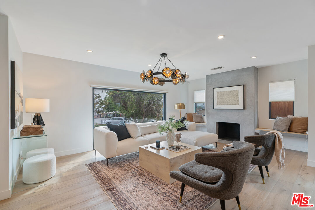 1645 South Sierra Bonita Avenue Los Angeles, CA 90019 - Photo 9 of 62 a living room with furniture a rug and a fireplace