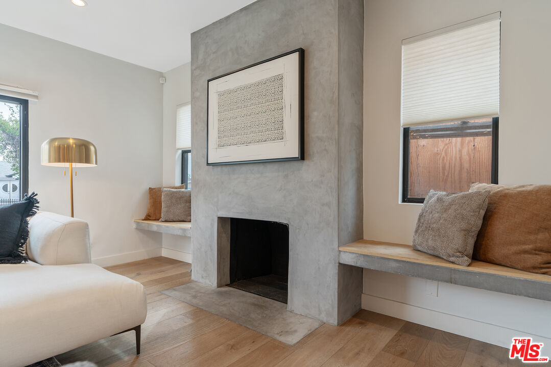 1645 South Sierra Bonita Avenue Los Angeles, CA 90019 - Photo 10 of 62 a living room with furniture and a fireplace