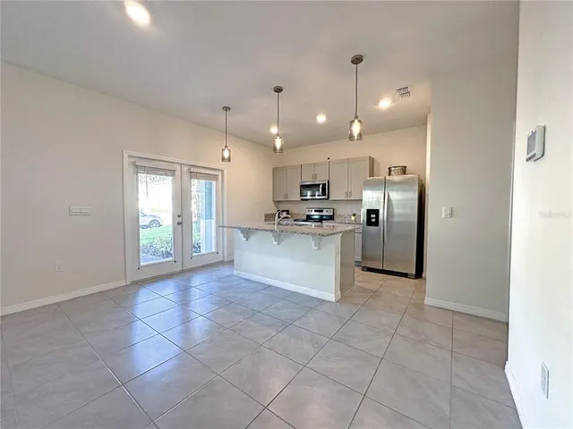 a large kitchen with cabinets and stainless steel appliances