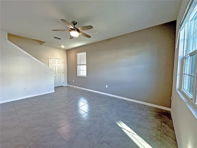 a view of a livingroom with a ceiling fan and window