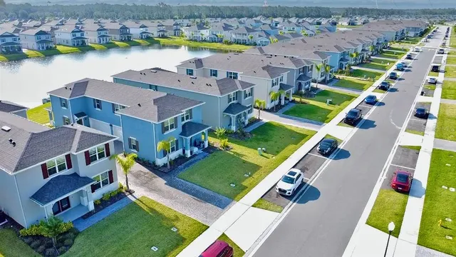 a view of a swimming pool with a yard from a balcony