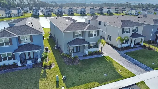 a front view of a house with a yard and potted plants