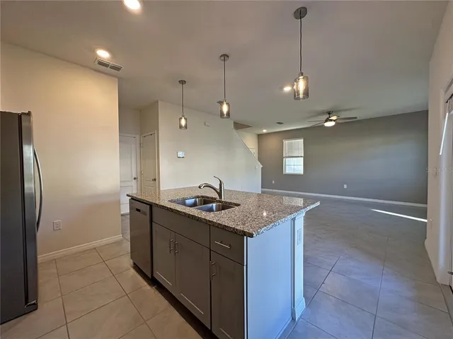 a kitchen with a sink a refrigerator and a stove