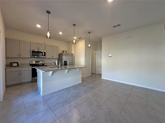 a large kitchen with cabinets and stainless steel appliances