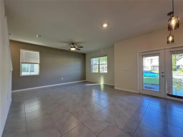 a view of an empty room with a fireplace and a window