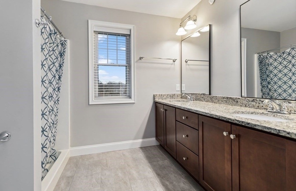38 Webster Street, Unit 2 Needham, MA 02494 - Photo 12 of 16 a bathroom with a granite countertop sink and a mirror