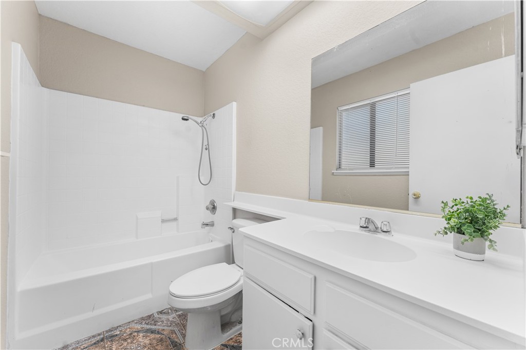 3542 East Ave R 10 Palmdale, CA 93550 - Photo 21 of 35 a bathroom with a sink toilet and shower