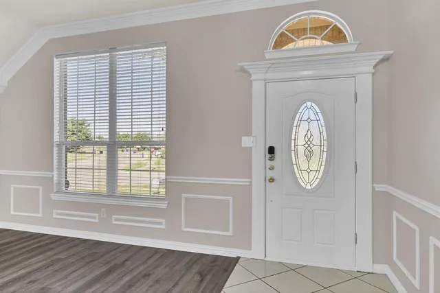 an view of a livingroom with wooden floor and a window