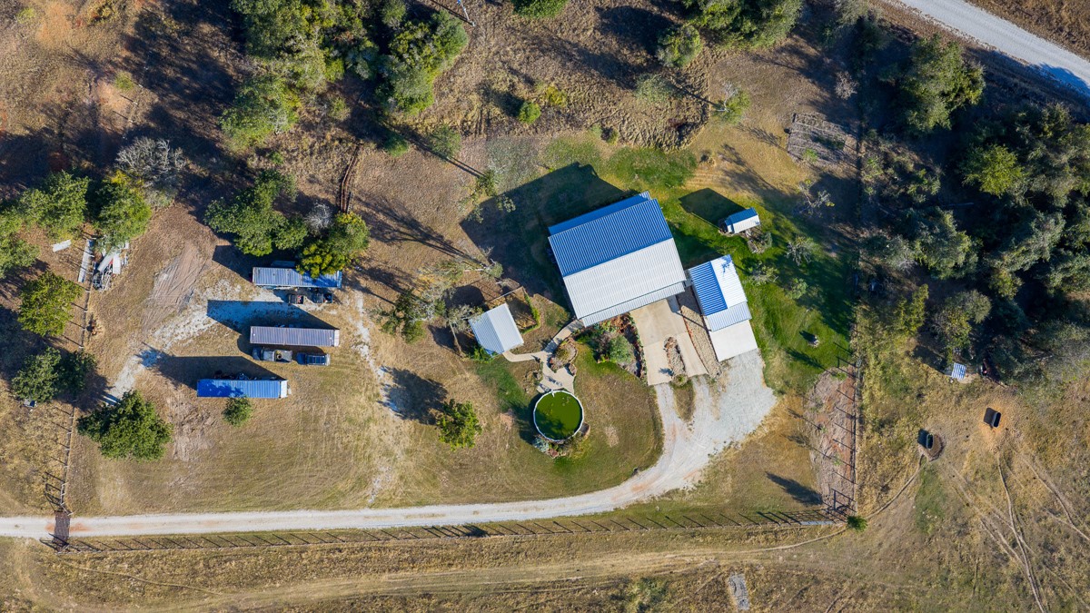 T-5 Providence Road Hearne, TX 77859 - Photo 33 of 39 an aerial view of a house with a yard and large trees