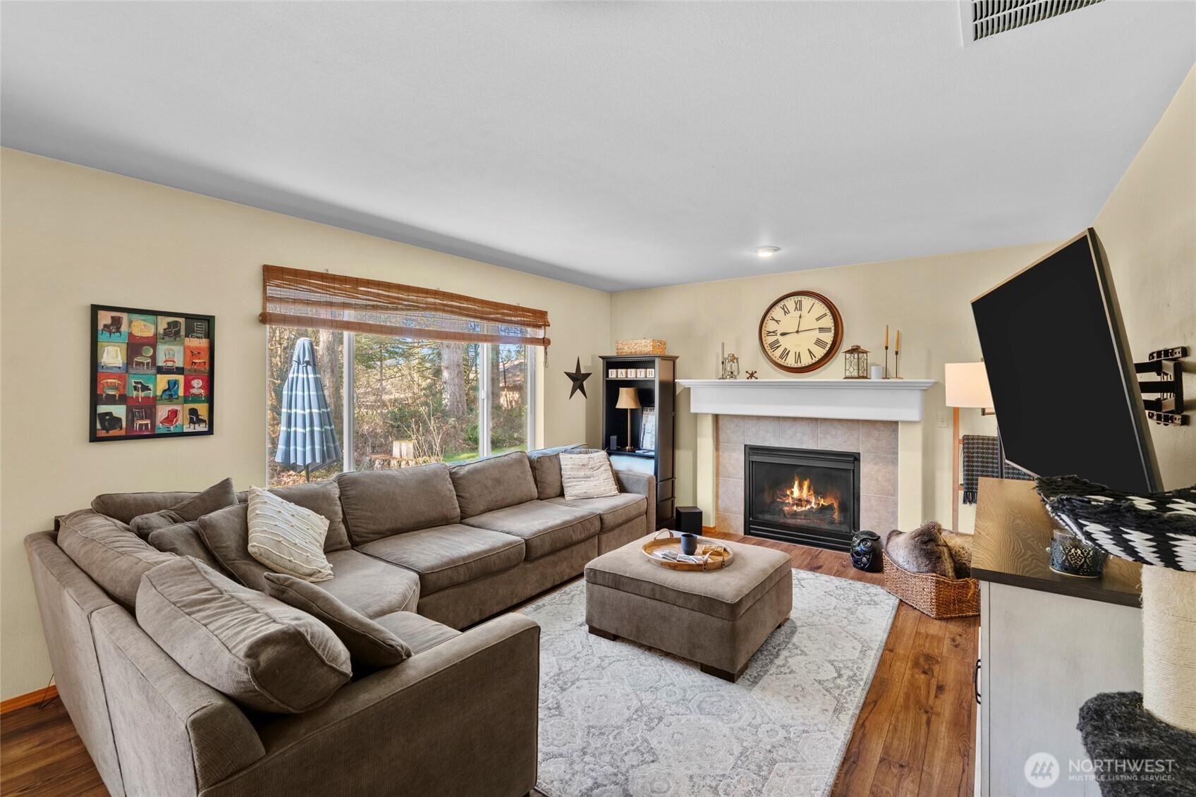 3349 68th Avenue Southwest Olympia, WA 98512 - Photo 11 of 36 a living room with furniture a flat screen tv and a fireplace