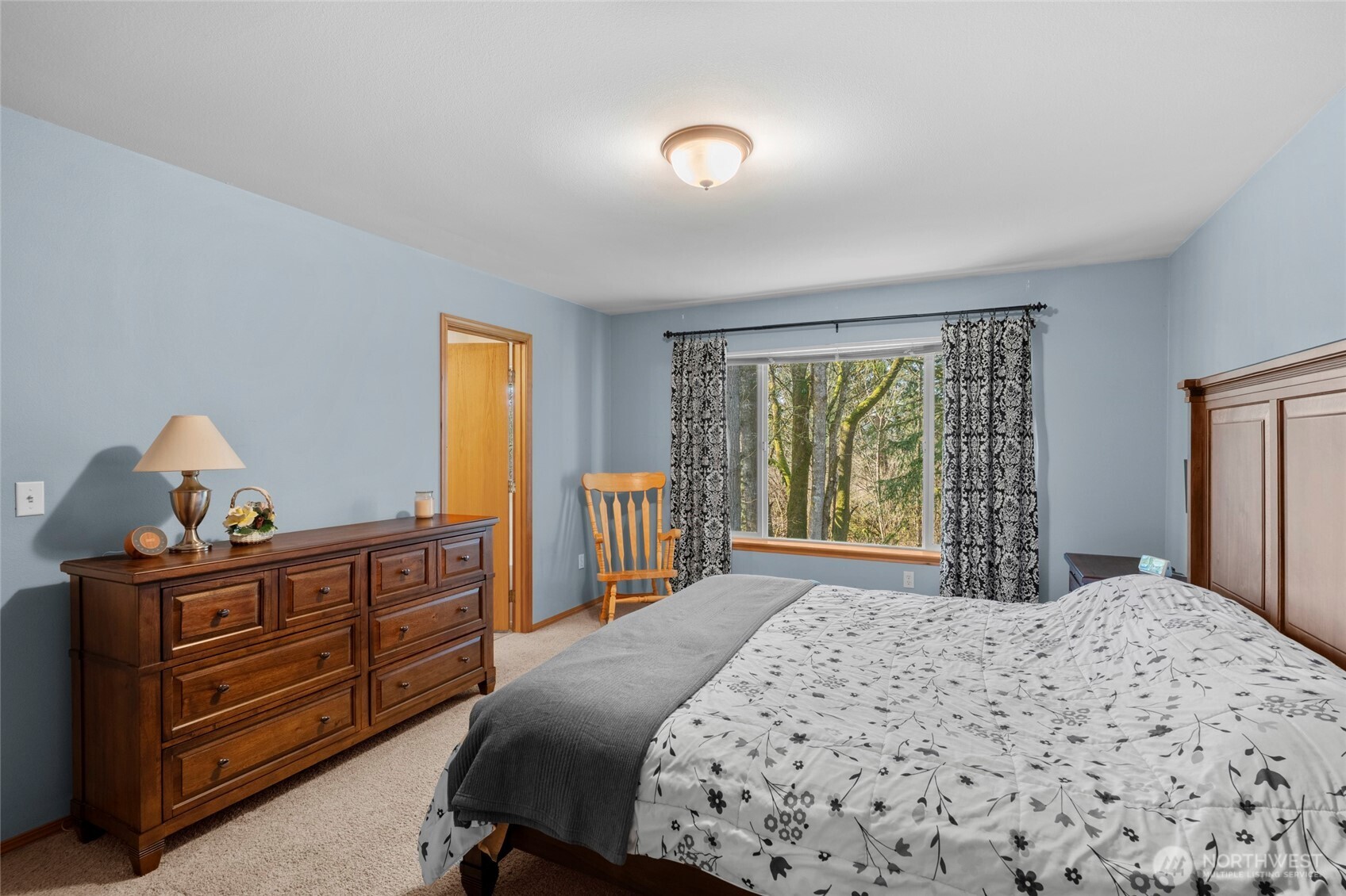 3349 68th Avenue Southwest Olympia, WA 98512 - Photo 17 of 36 a bedroom with a bed and a dresser next to a window