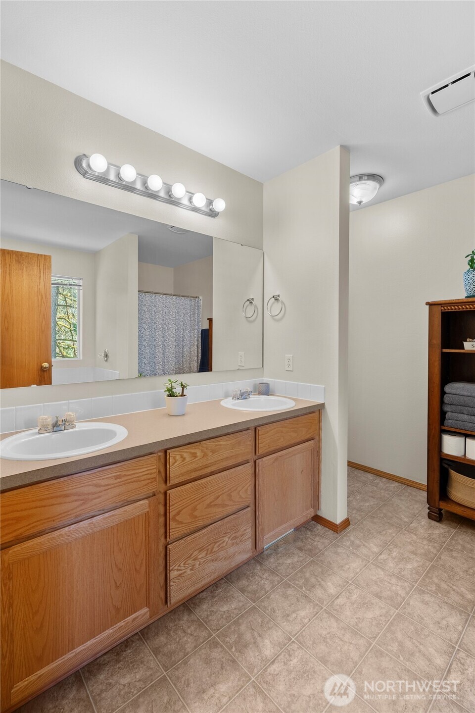 3349 68th Avenue Southwest Olympia, WA 98512 - Photo 18 of 36 a spacious bathroom with a granite countertop sink and a mirror
