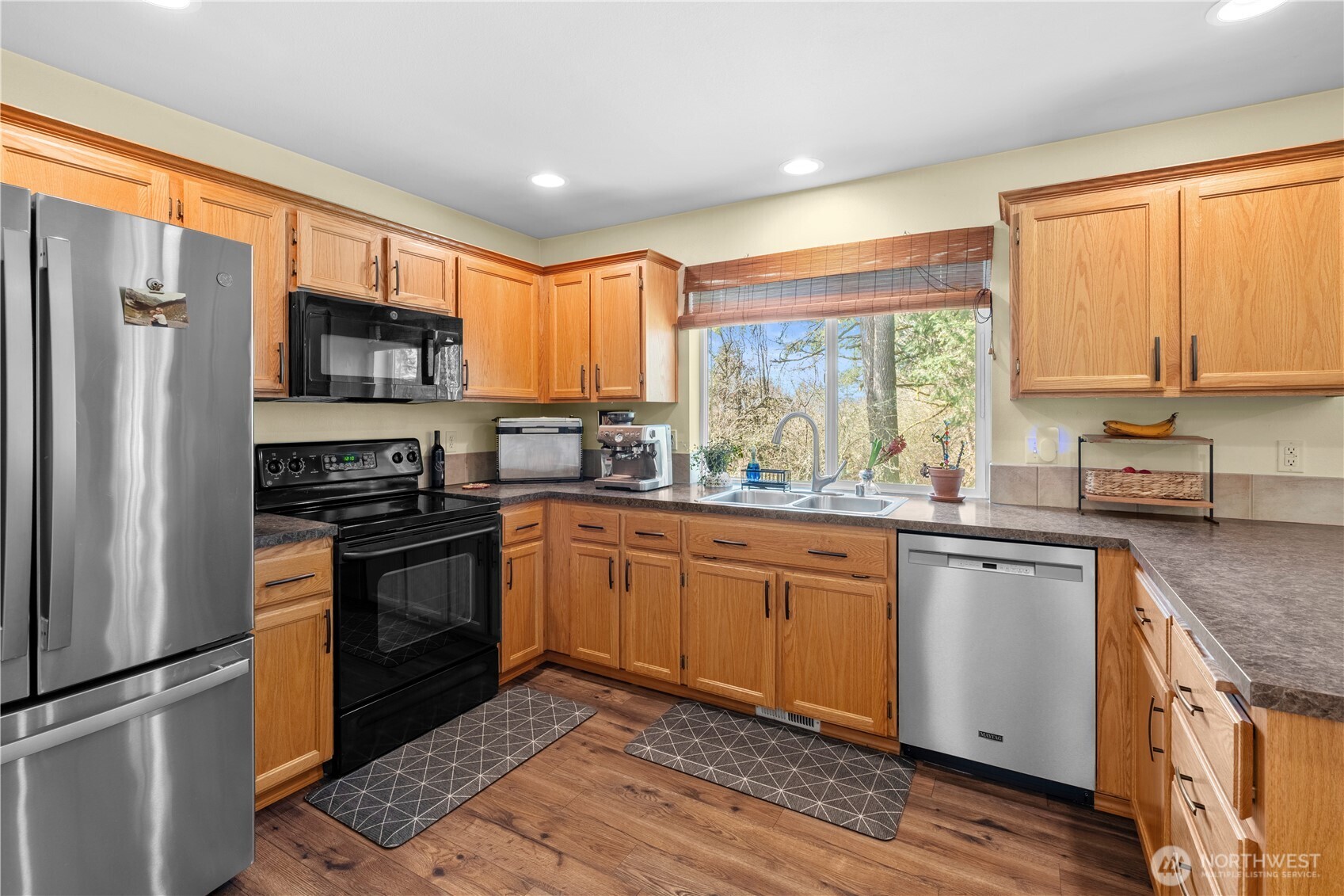 3349 68th Avenue Southwest Olympia, WA 98512 - Photo 8 of 36 a kitchen with stainless steel appliances granite countertop a stove a sink and a refrigerator