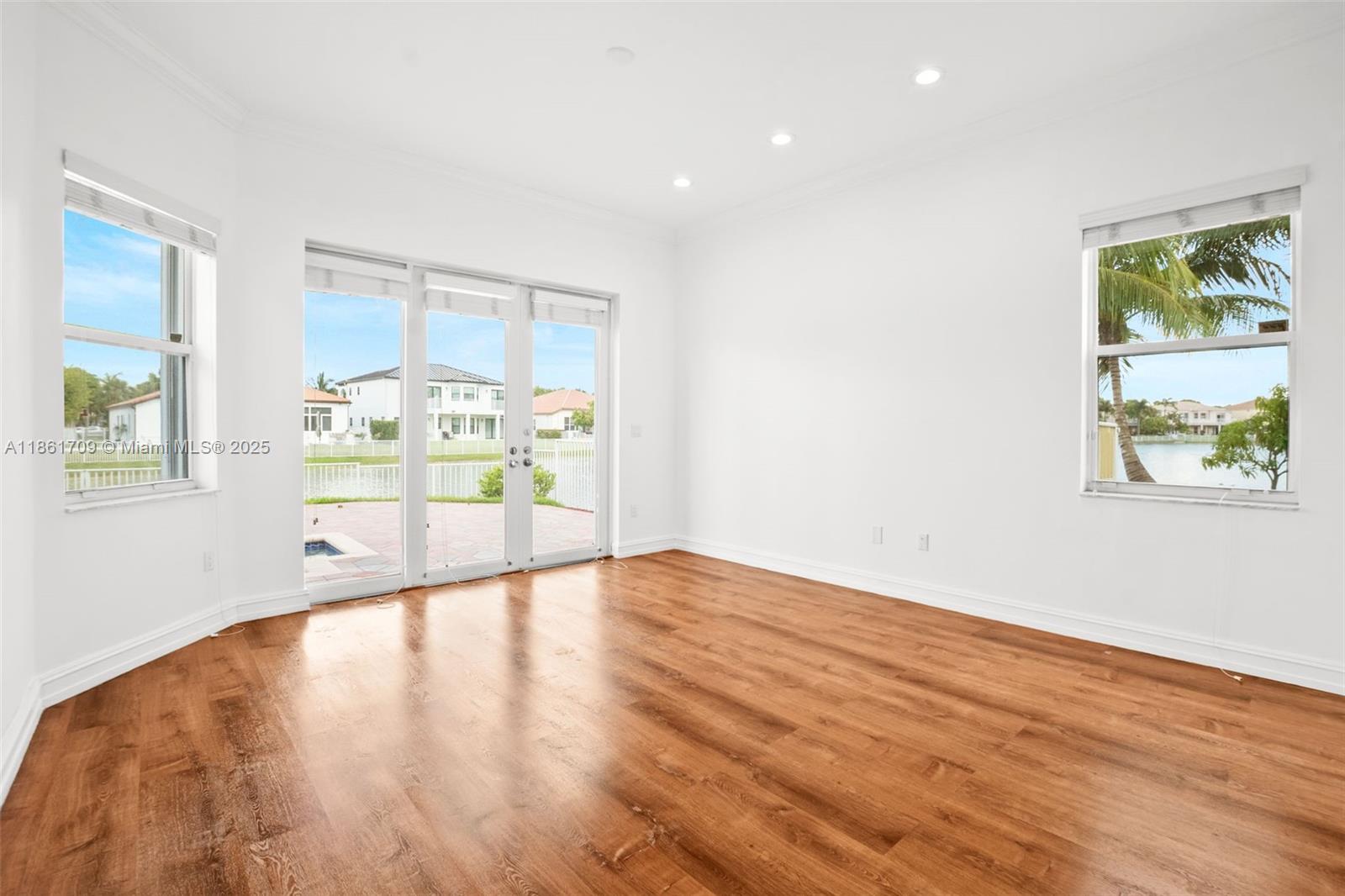5168 Southwest 157th Avenue Miramar, FL 33027 - Photo 11 of 30 a view of an empty room with wooden floor and a window