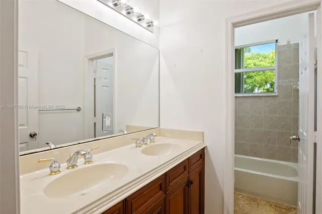 a bathroom with a tub sink and a mirror