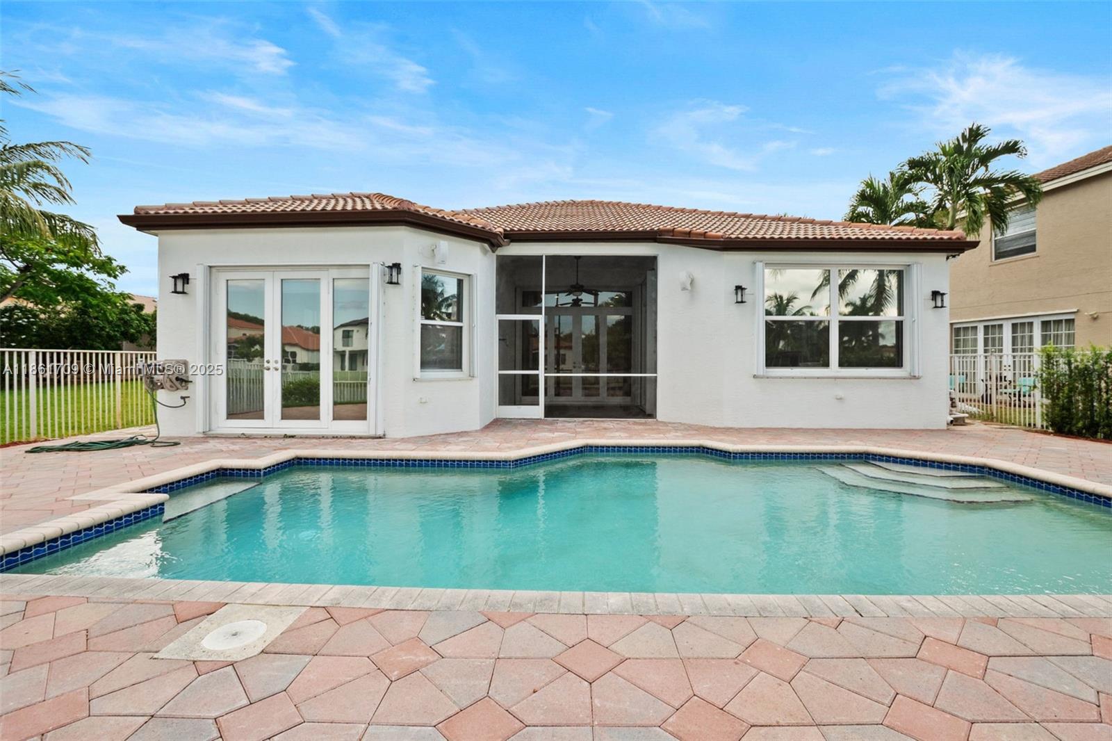 5168 Southwest 157th Avenue Miramar, FL 33027 - Photo 27 of 30 a view of a house with a swimming pool and a yard