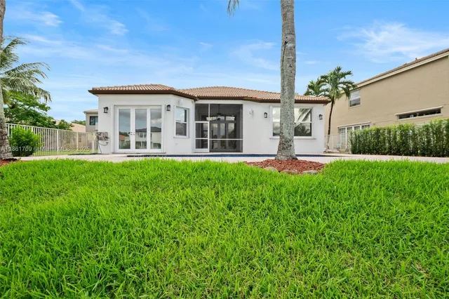 a front view of a house with a yard table and chairs