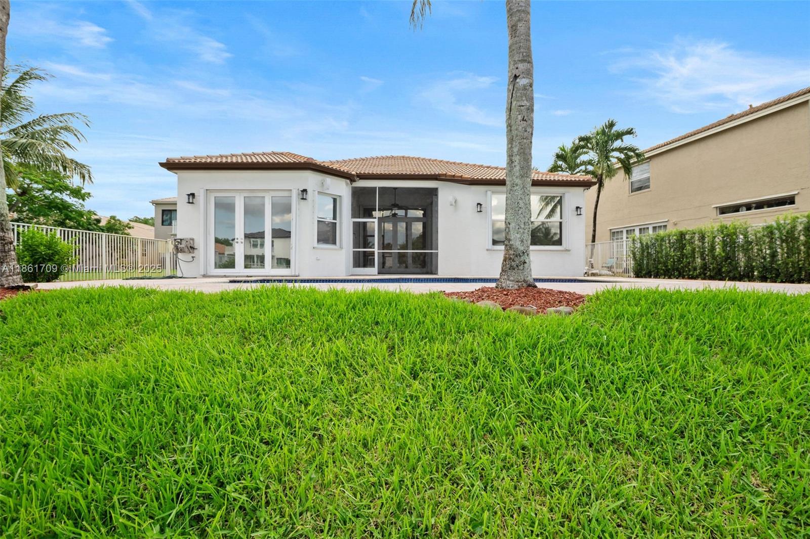 5168 Southwest 157th Avenue Miramar, FL 33027 - Photo 30 of 30 a front view of a house with a yard table and chairs