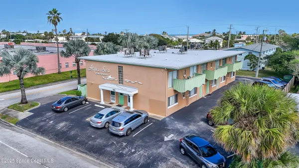an aerial view of a house with garden space and street view