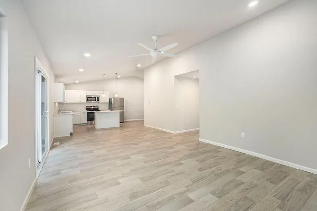 a view of kitchen dining table chairs and refrigerator