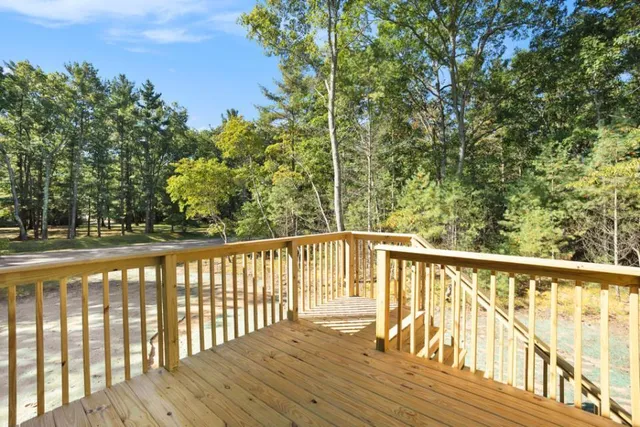 a view of balcony with wooden floor and fence