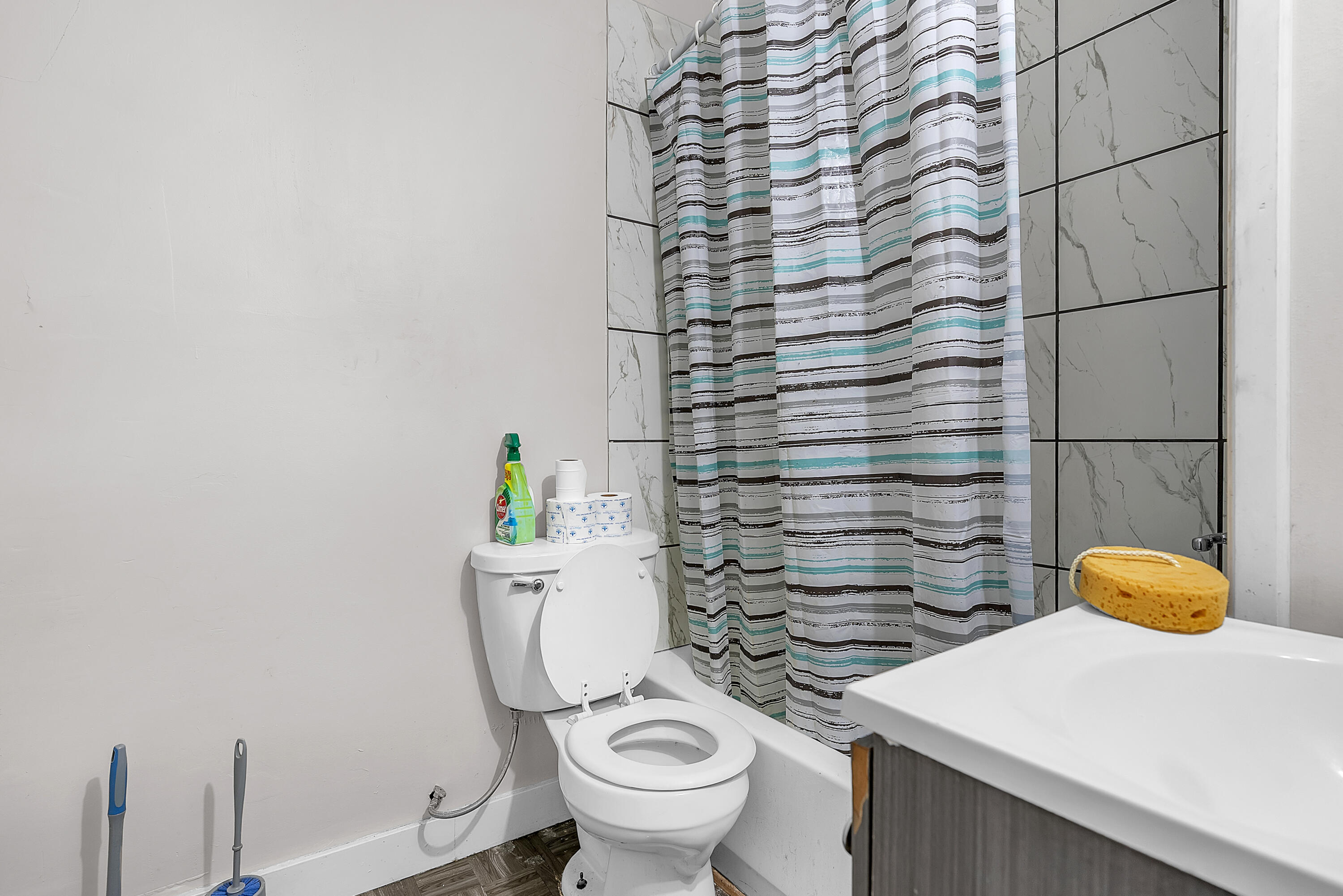 15 Rimbach Street Hammond, IN 46320 - Photo 18 of 31 a bathroom with a toilet and a shower curtain