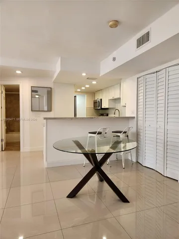 a open kitchen with stainless steel appliances kitchen island granite countertop a sink and cabinets