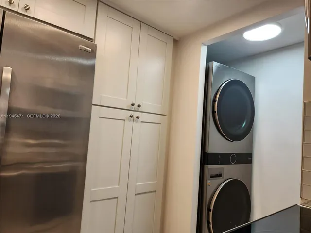a close view of a utility room with dryer and washer