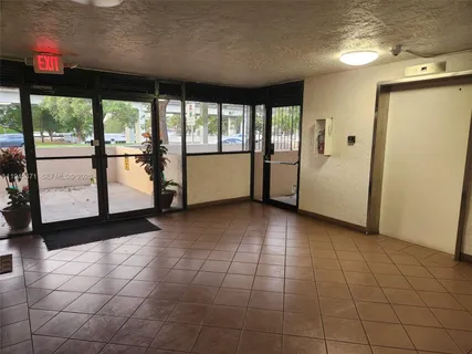 a view of a livingroom with an empty space and a window