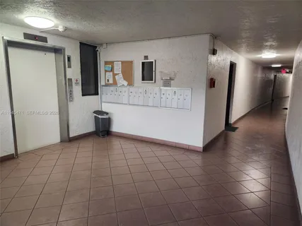 a view of a refrigerator in kitchen and living room
