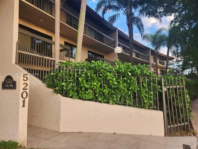 a view of a building with a small yard and potted plants