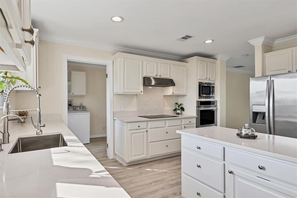 755 Colgate Road Venice, FL 34293 - Photo 12 of 53 a kitchen with stainless steel appliances kitchen island granite countertop a sink and cabinets