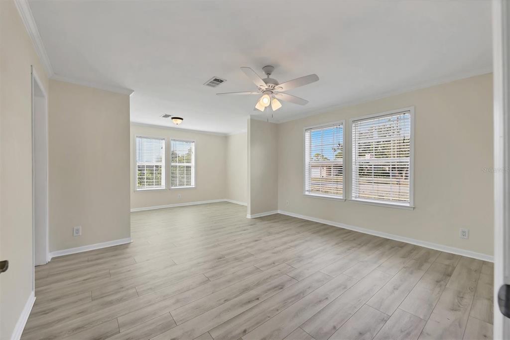 755 Colgate Road Venice, FL 34293 - Photo 19 of 53 a view of an empty room with a window and wooden floor