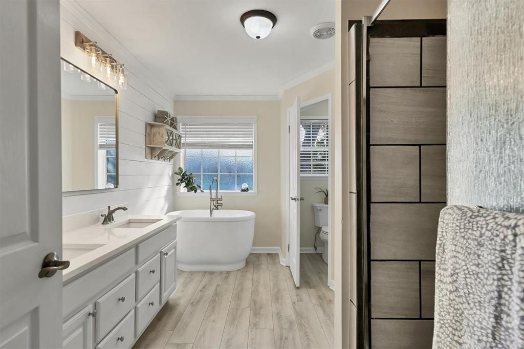 755 Colgate Road Venice, FL 34293 - Photo 22 of 53 a bathroom with a double vanity sink toilet mirror and bathtub