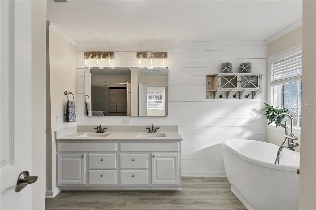 755 Colgate Road Venice, FL 34293 - Photo 23 of 53 a bathroom with a tub a sink double vanity and a mirror