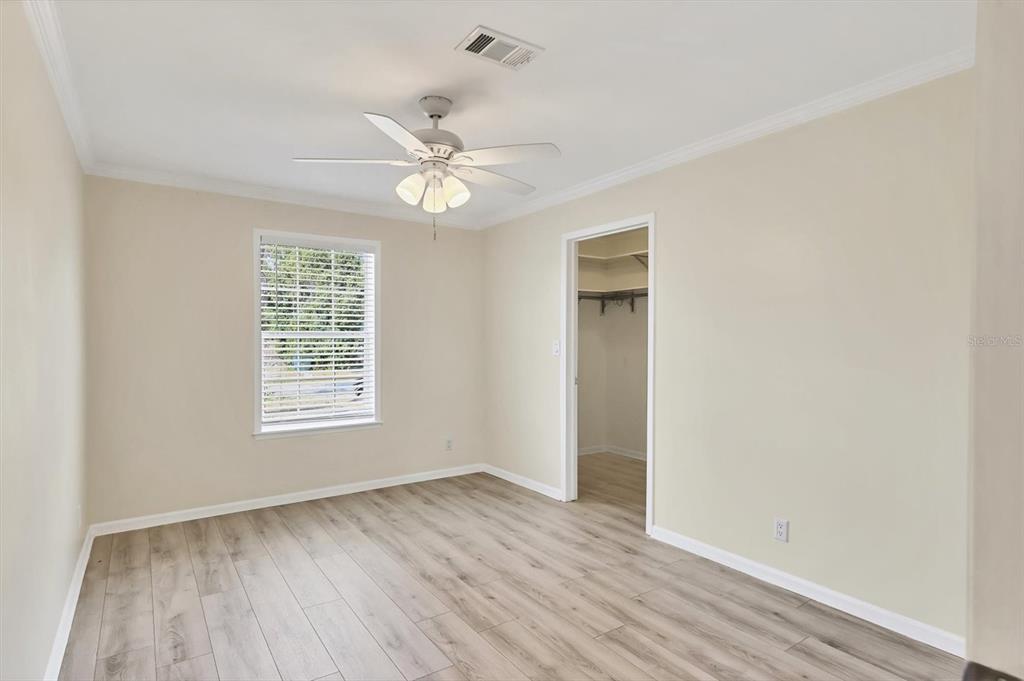 755 Colgate Road Venice, FL 34293 - Photo 28 of 53 an empty room with wooden floor fan and windows