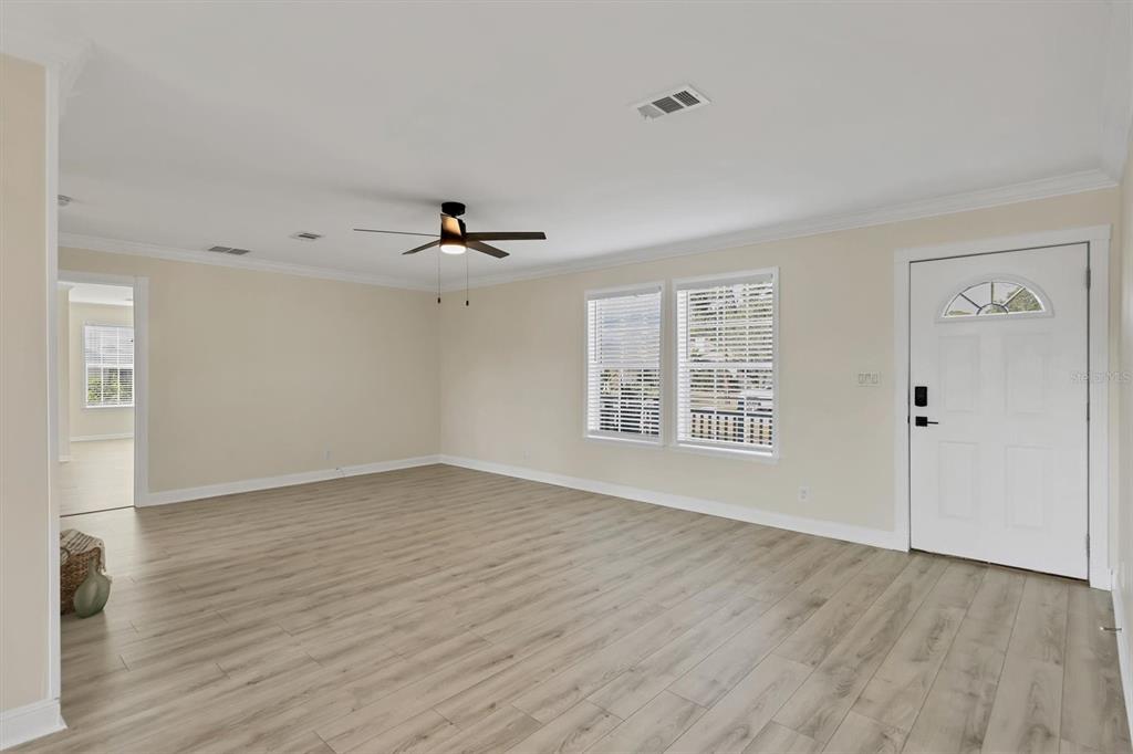 755 Colgate Road Venice, FL 34293 - Photo 5 of 53 a view of an empty room with wooden floor and a window