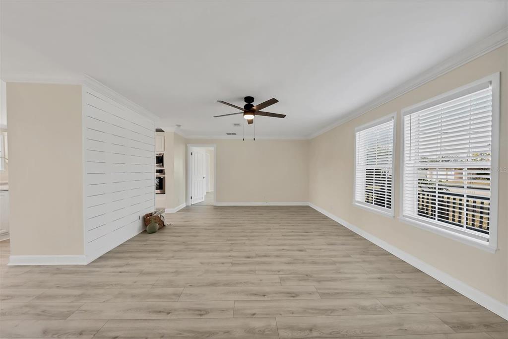 755 Colgate Road Venice, FL 34293 - Photo 8 of 53 a view of an empty room with a window and wooden floor