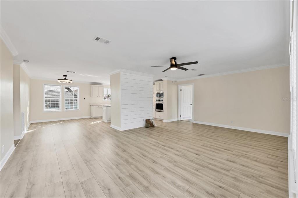 755 Colgate Road Venice, FL 34293 - Photo 9 of 53 a view of empty room with wooden floor and ceiling fan