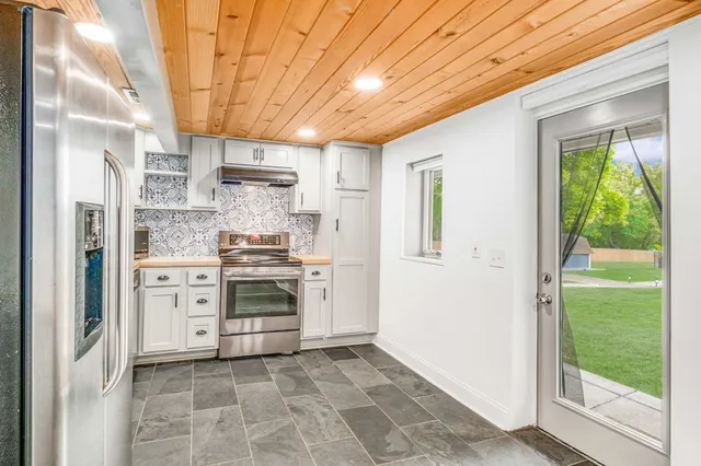 a kitchen with a stove cabinets and a appliances
