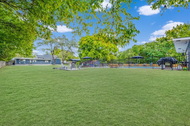 a view of building with garden space and trees