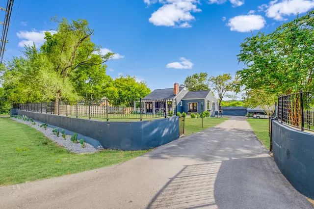 a view of yard with swimming pool and wooden fence