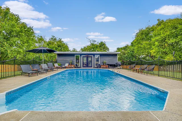 swimming pool view with a seating space