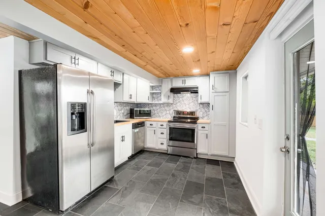 a kitchen with a refrigerator a sink and dishwasher