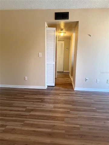 a view of a kitchen with fridge and rack