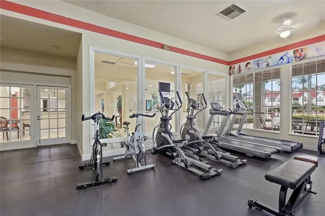 a living room with furniture and a ceiling fan