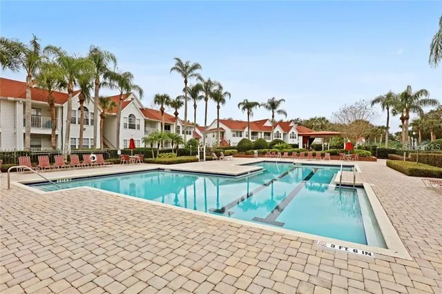 a view of a tennis ground with large trees