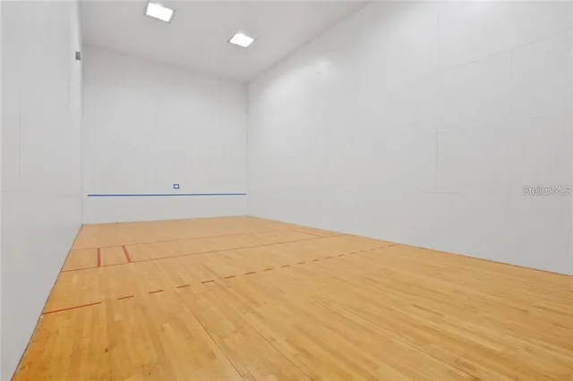 a view of a livingroom with wooden floor and a ceiling fan