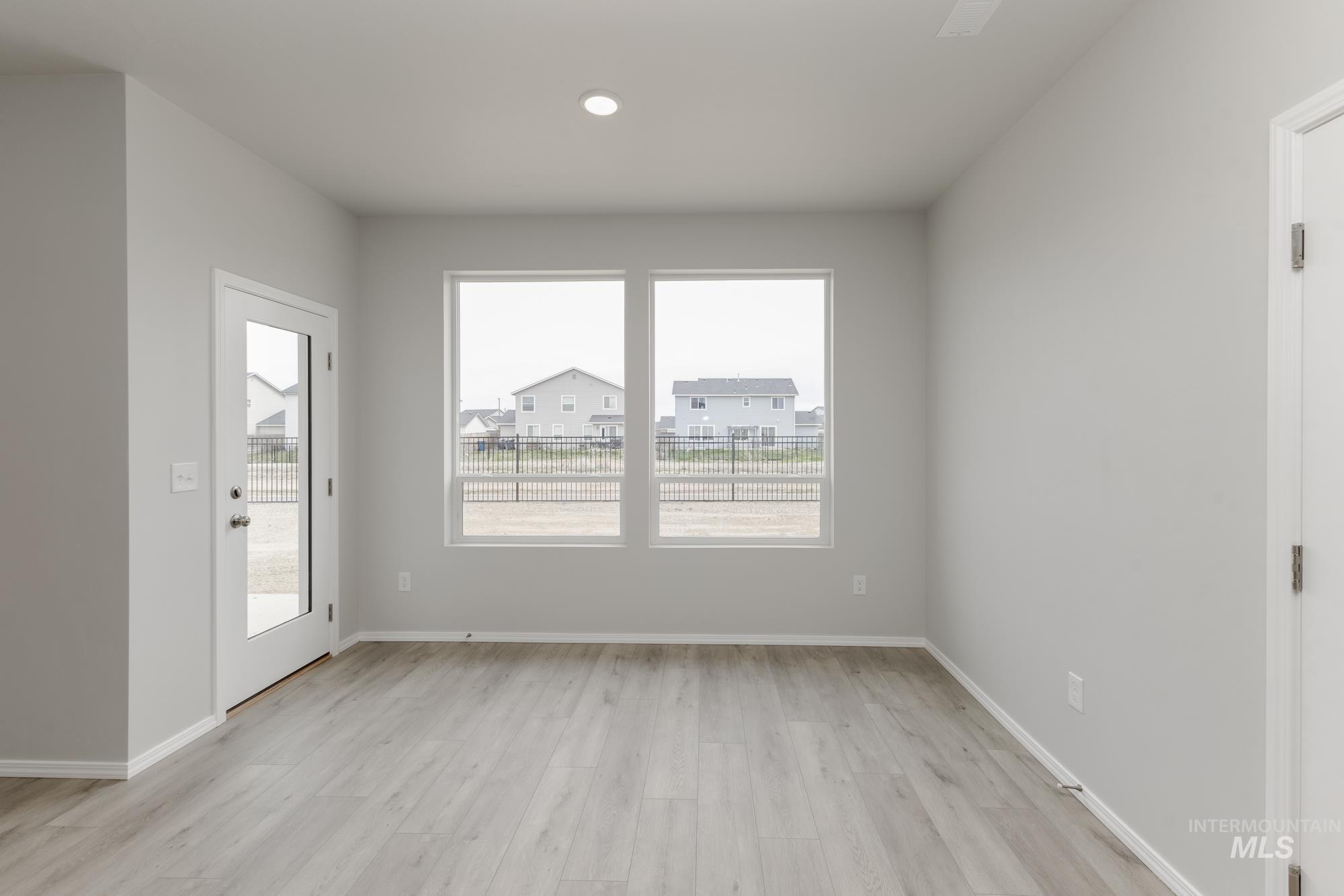 12842 Ropers Street Nampa, ID 83651 - Photo 7 of 29 Spacious interior with neutral gray walls and light wood-finish flooring